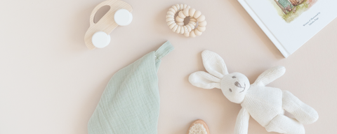 Curated organic baby toys and accessories displayed with colored organics clothing items