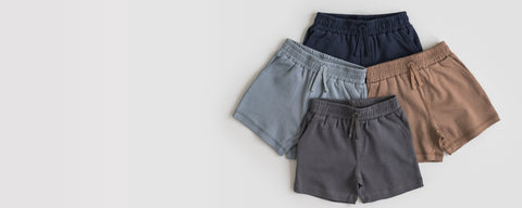 Organic cotton baby shorts collection in natural colors for boys and girls