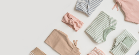 Baby wearing organic striped outfit from timeless collection