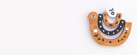 Natural wooden toys for babies and kids displayed in modern nursery setting