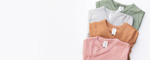 Organic cotton kimono bodysuits for babies in various colors with wrap-style design