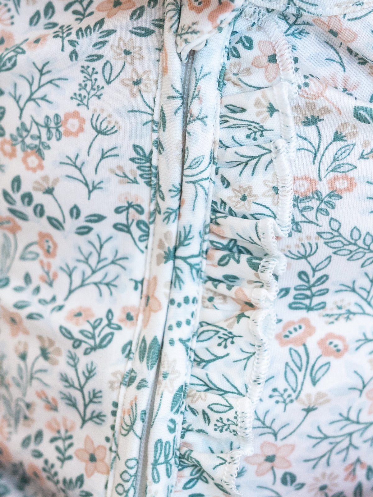 Neve Ruffle Zipper Footed Romper - Merion Floral / Laguna + Shell Sale : Baby : One Pieces : Bodysuits : Long Sleeves KENDI by Colored Organics Neve Ruffle Zipper Footed Romper | Colored Organics®